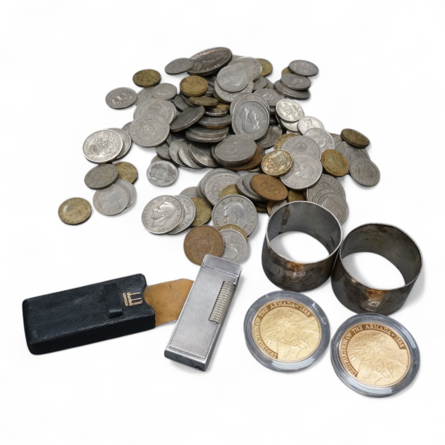 Sundry items comprising a cased Dunhill lighter, coins and napkin rings